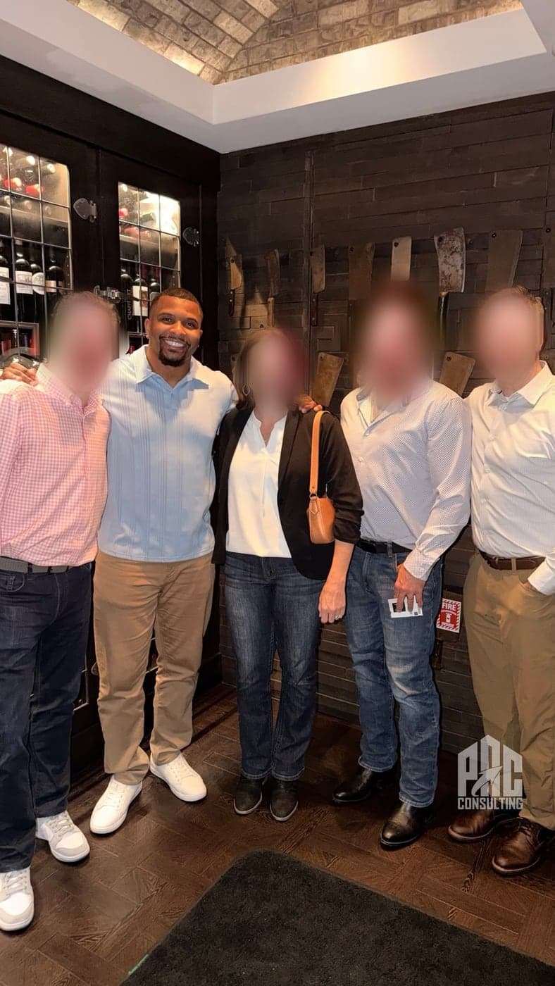 Phillip Crawford with a group of business owners he has worked with, their faces blurred for confidentiality